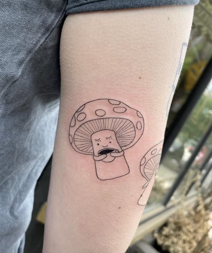 fine line mushroom character arm tattoo by Ale Muñoz, Philadelphia PA