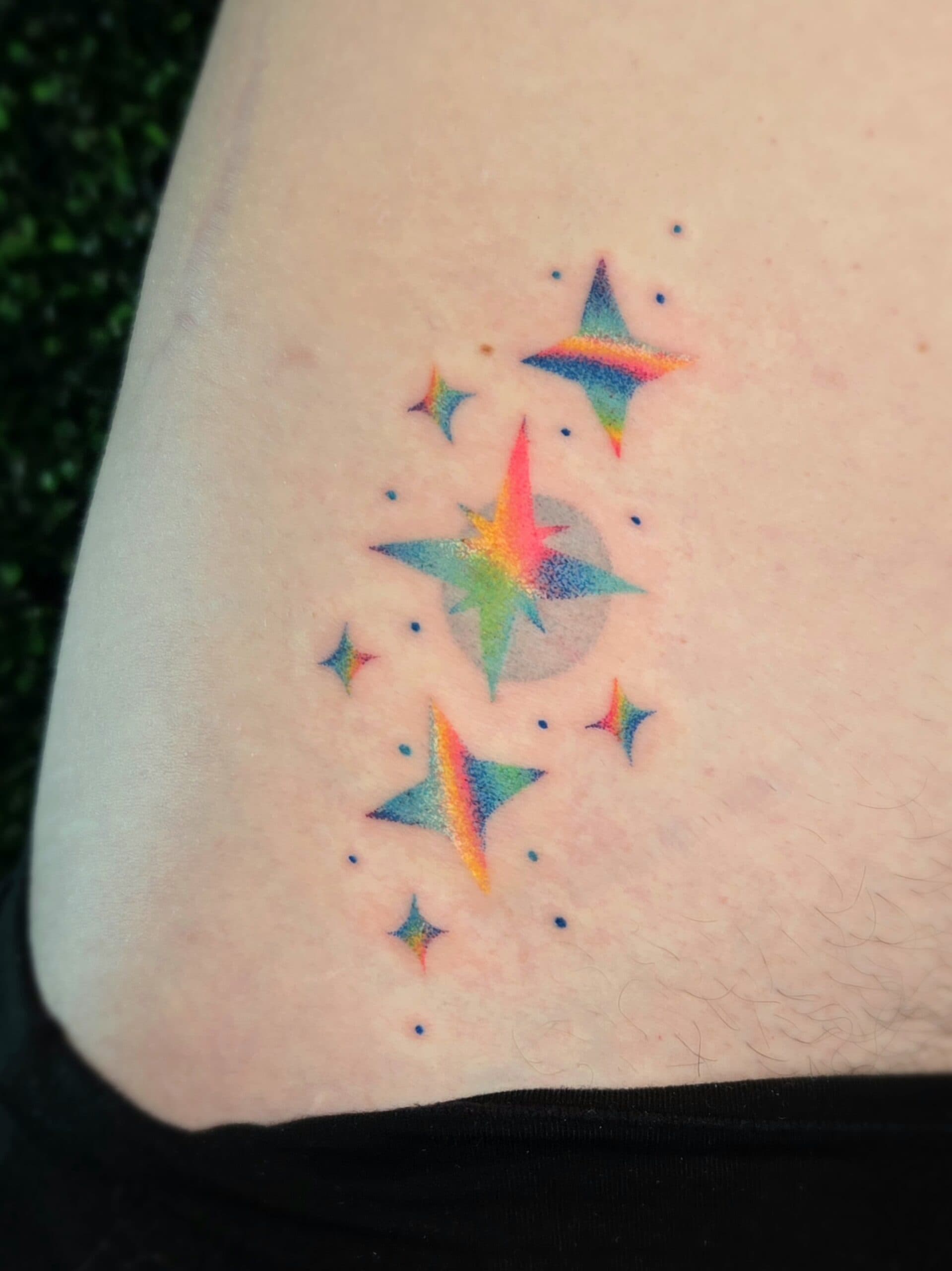 rainbow sparkle stars hip tattoo by Bird, Philadelphia PA