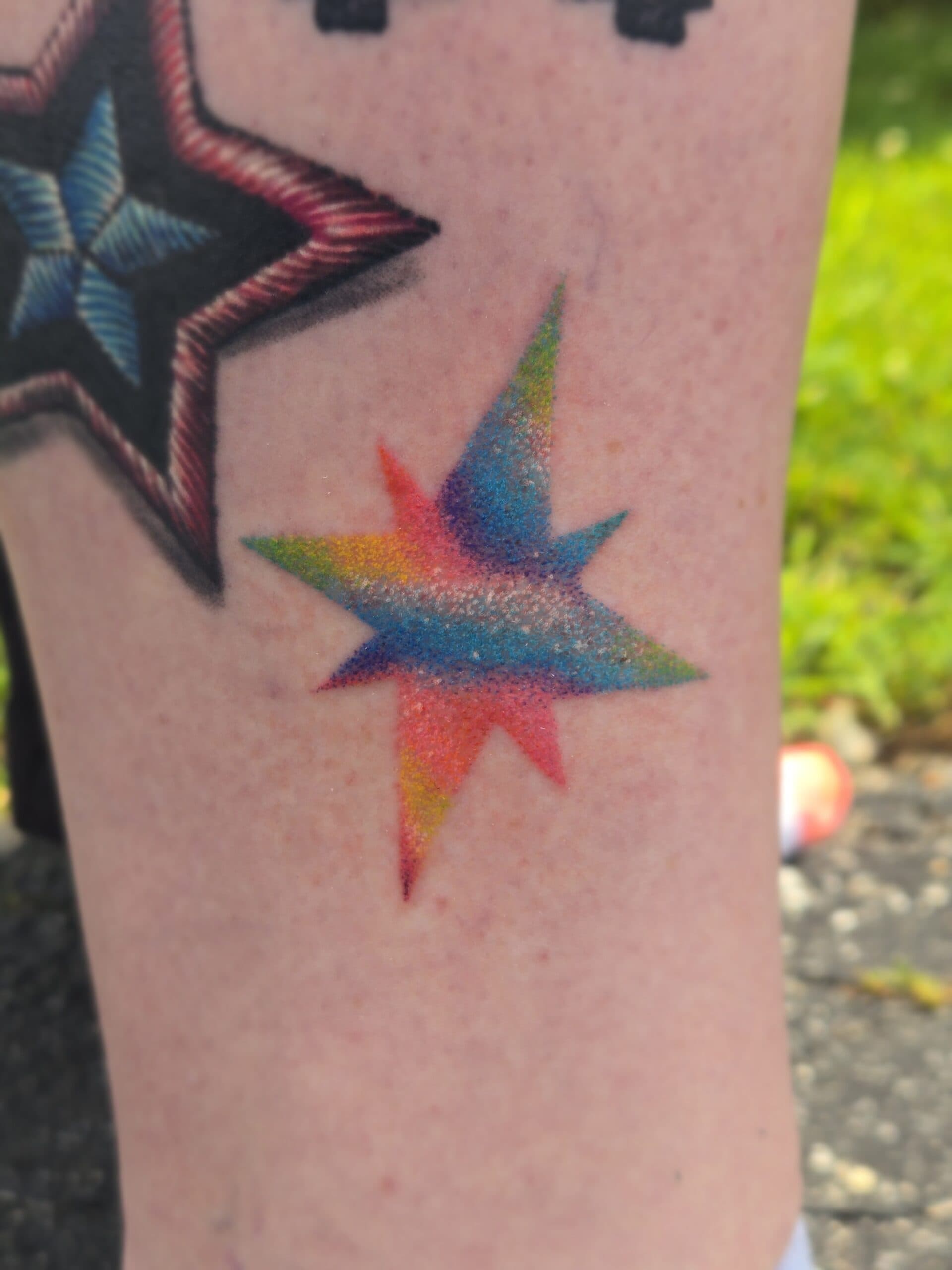 rainbow star leg tattoo by Bird, Philadelphia PA