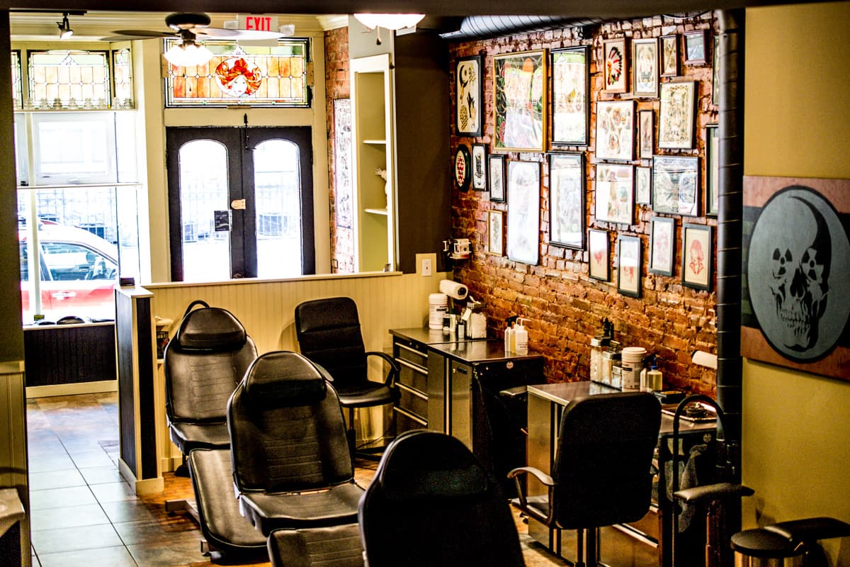 Frequency Tattoo studio interior with workstations and flash art